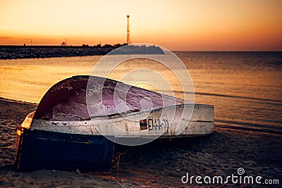 Fisherman boat at the coast of the Baltic Sea near the gates to the port of Klaipeda, Lithuania Editorial Stock Photo