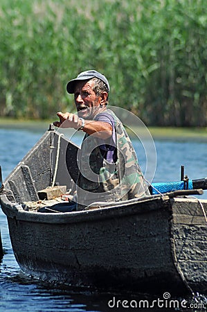 Fisherman in a boat in the Danube delta, Romania Editorial Stock Photo
