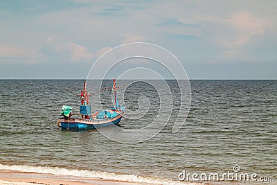 Fisherman boat float in the sea ocean near sand beach shore with hazy blue sky background landscape Editorial Stock Photo