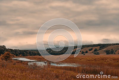 Fisherman in a boat on a small lake in a cloudy hilly valley Stock Photo