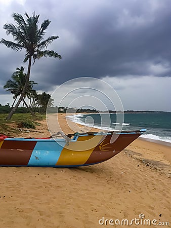 Fisherman boatpiroga on the Indian ocean shore. Hambantota, Sri Lanka Editorial Stock Photo