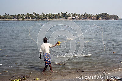 Fisherman casting nets in sea water at Kochi Editorial Stock Photo