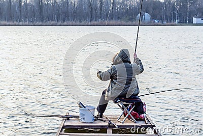 Fisherman casting spinning rod scenic autumn close up rear view Editorial Stock Photo
