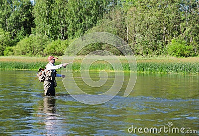 Fisherman catches of chub fly fishing in the Chusovaya river Stock Photo