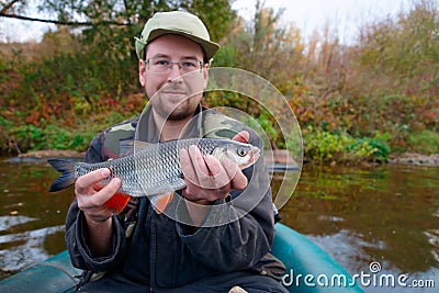 Fisherman with chub Stock Photo