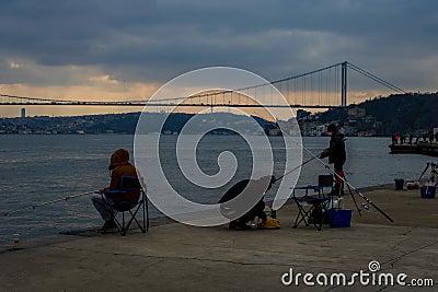 fisherman fishes on Bosphorus Istanbul on a Foggy sunrise Editorial Stock Photo