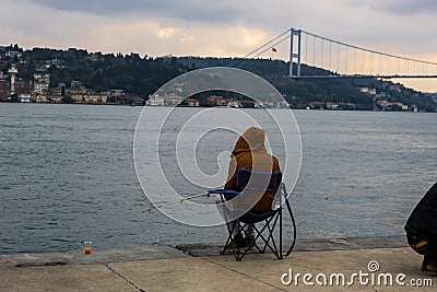 fisherman fishes on Bosphorus Istanbul on a Foggy sunrise Editorial Stock Photo