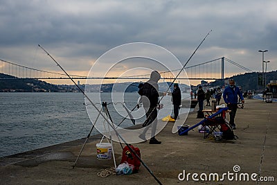 fisherman fishes on Bosphorus Istanbul on a Foggy sunrise Editorial Stock Photo