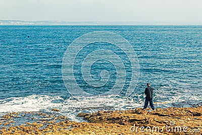 Fisherman fishing in Oeiras, Portugal Editorial Stock Photo