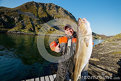 Fisherman with huge fish showing thumb Stock Photo