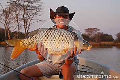 Fisherman with large carp Stock Photo