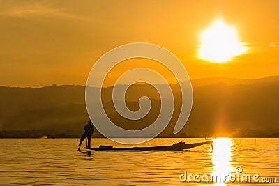 Fisherman with Leg rowing during Sunset, inle lake in Myanmar ( Stock Photo