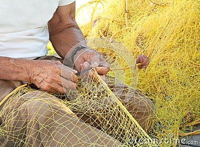 Fisherman Mending His Fishing Net In Greece Royalty Free 