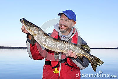 Fisherman Poses with Northern Pike Fish Stock Photo