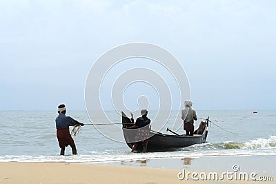 Fisherman pulls his fishing boat Editorial Stock Photo