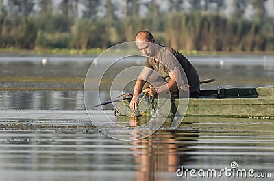 Fisherman pulls net Editorial Stock Photo