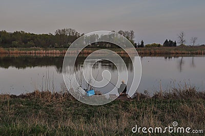 Fisherman on the quiet evening on the river Tisa Editorial Stock Photo