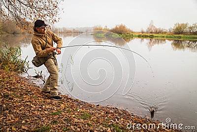 Fisherman on the river bank Stock Photo