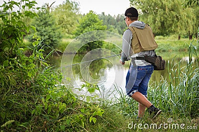 Fisherman on the river bank Stock Photo