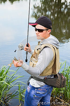 Fisherman on the river bank Stock Photo