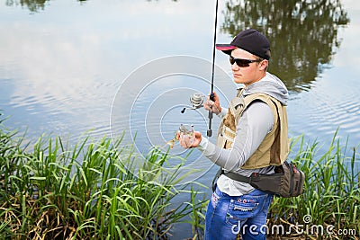 Fisherman on the river bank Stock Photo