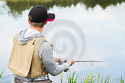 Fisherman on the river bank Stock Photo