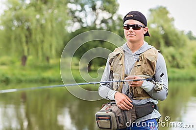 Fisherman on the river bank Stock Photo