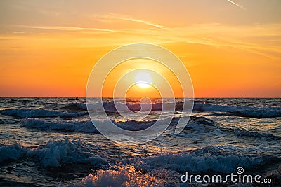 Fisherman sailing with his boat on beautiful sunrise over the sea Stock Photo