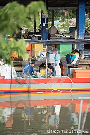 Fisherman selling fish at the pier Editorial Stock Photo