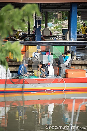 Fisherman selling fish at the pier Editorial Stock Photo