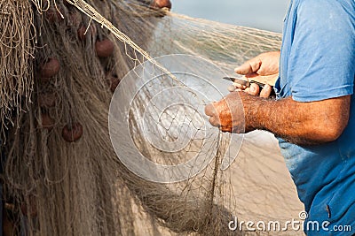 Fisherman is settings up his fishing net at the beach Stock Photo