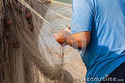 Fisherman is settings up his fishing net at the beach Stock Photo