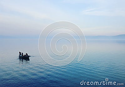 Fisherman in a small boat at sea Of Galilee At Dusk. Editorial Stock Photo