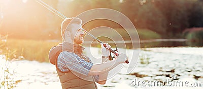 Fisherman with a spinning and bait catching fish on a lake or river. Man on a weekend with a fishing road. Hobby and Stock Photo