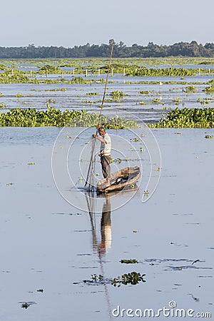 Fisherman standing on his boat at Ban Thale Noi lagoon, Thailand Editorial Stock Photo