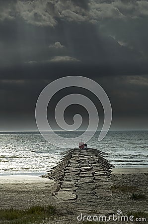 Fisherman on a Stone Pier Stock Photo