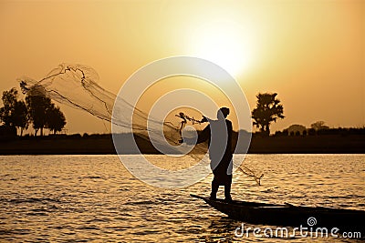 Fisherman at sunset Stock Photo