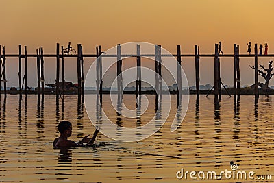 Fisherman and Sunset at U Bein Teakwood Bridge , Amarapura in M Editorial Stock Photo