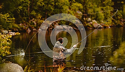 Fisherman using rod fly fishing in mountain river Stock Photo
