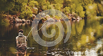 Fisherman using rod fly fishing in river morning sunrise banner Stock Photo