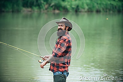 Fisherman using rod flyfishing in mountain river. A fly fisherman fishing for wild trout on the river in the forest. Stock Photo