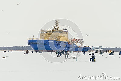 Fishermans on ice. Mans fishing on ice on gulf on Finland near Kronshtadt, Saint Petersburg, Russia, 03 February 2018 Editorial Stock Photo