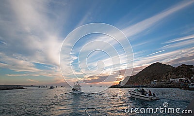 Fishermans sunrise view of fishing boats going out for the day past Lands End in Cabo San Lucas in Baja California Mexico Editorial Stock Photo