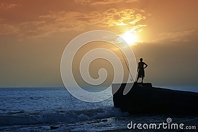 Fishermen on the beach in the evening against the sunset Editorial Stock Photo