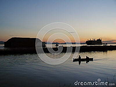 Fishermen in a boat, big container ship and tugboat towing a barge Stock Photo