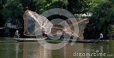 Casting nets from river boats, Hue, Vietnam Editorial Stock Photo