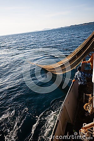 Fishermen choose a trawl with fish Stock Photo