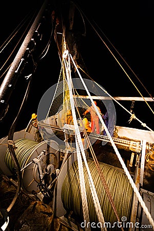 Fishermen choose a trawl with fish Stock Photo