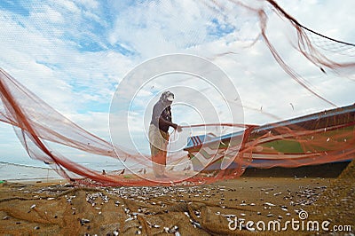 Fishermen collecting fish Editorial Stock Photo