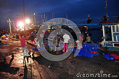 Fishermen are collecting and sorting fisheries after a long day fishing in the Hon Ro seaport, Nha Trang city Editorial Stock Photo